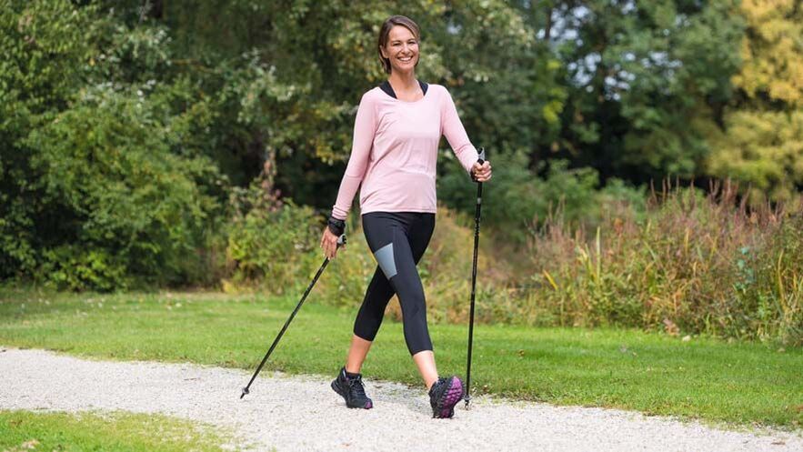 A woman is busy walking to prevent back pain