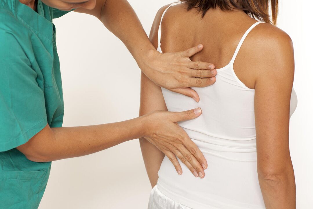 Doctor checks back for shoulder blade pain
